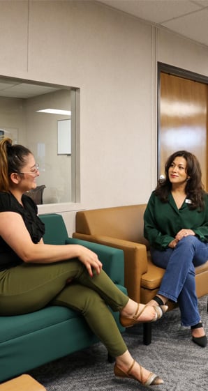 Maria assisting member in lobby